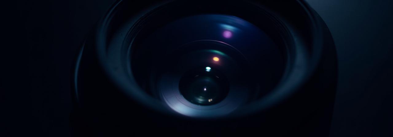 Close up of a professional high-end camera lens with reflections