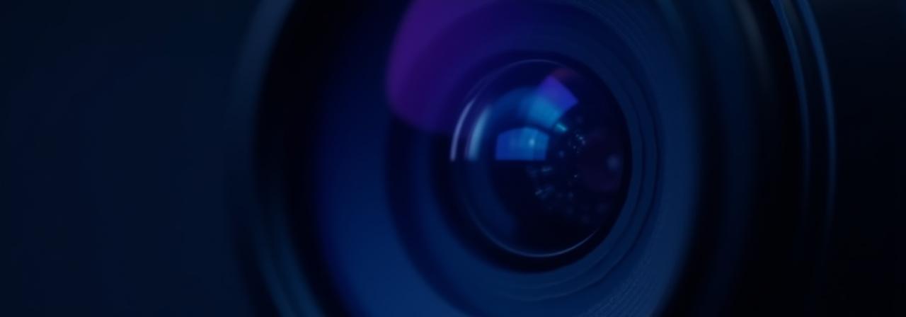 Close up of a professional camera lens with light reflections